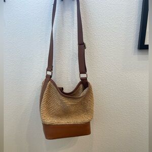 Woven bag with leather trim and strap